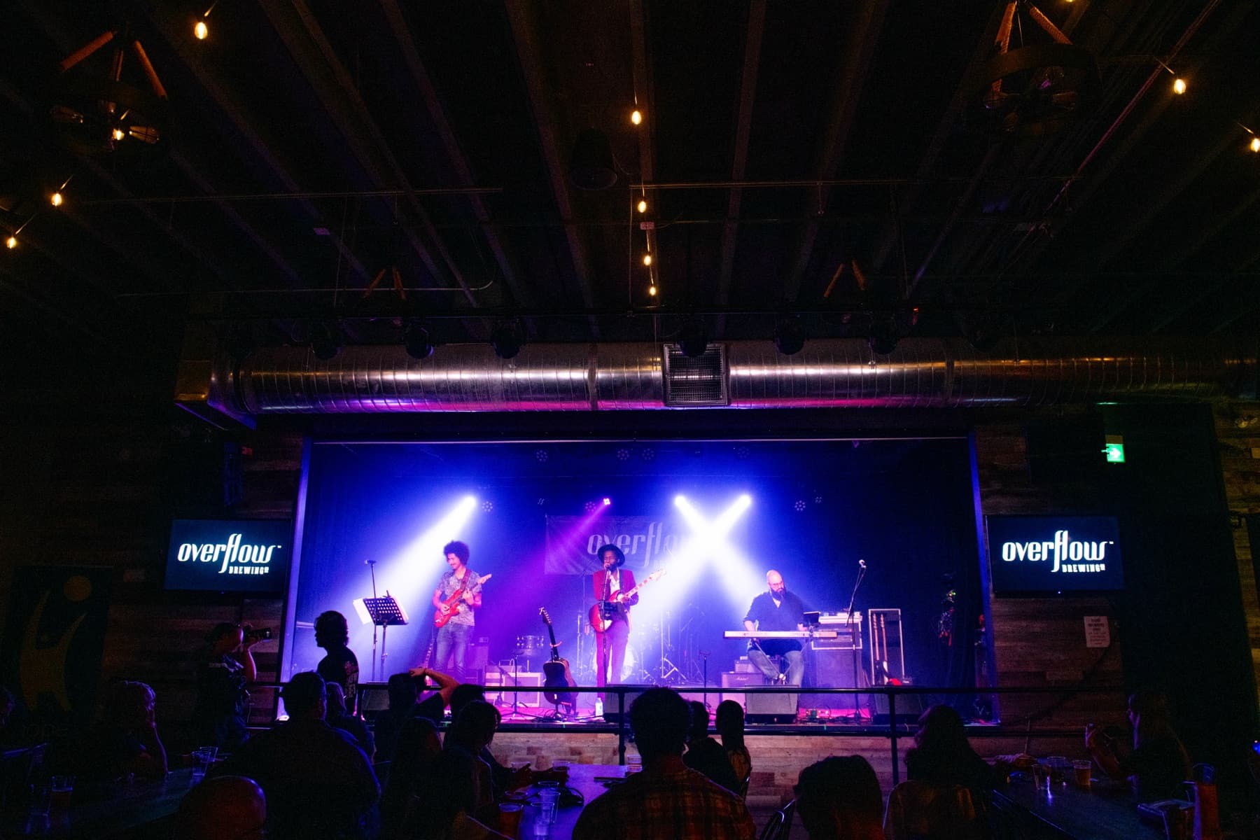 Almyr Jules and band on stage at Overflow Brewing Company