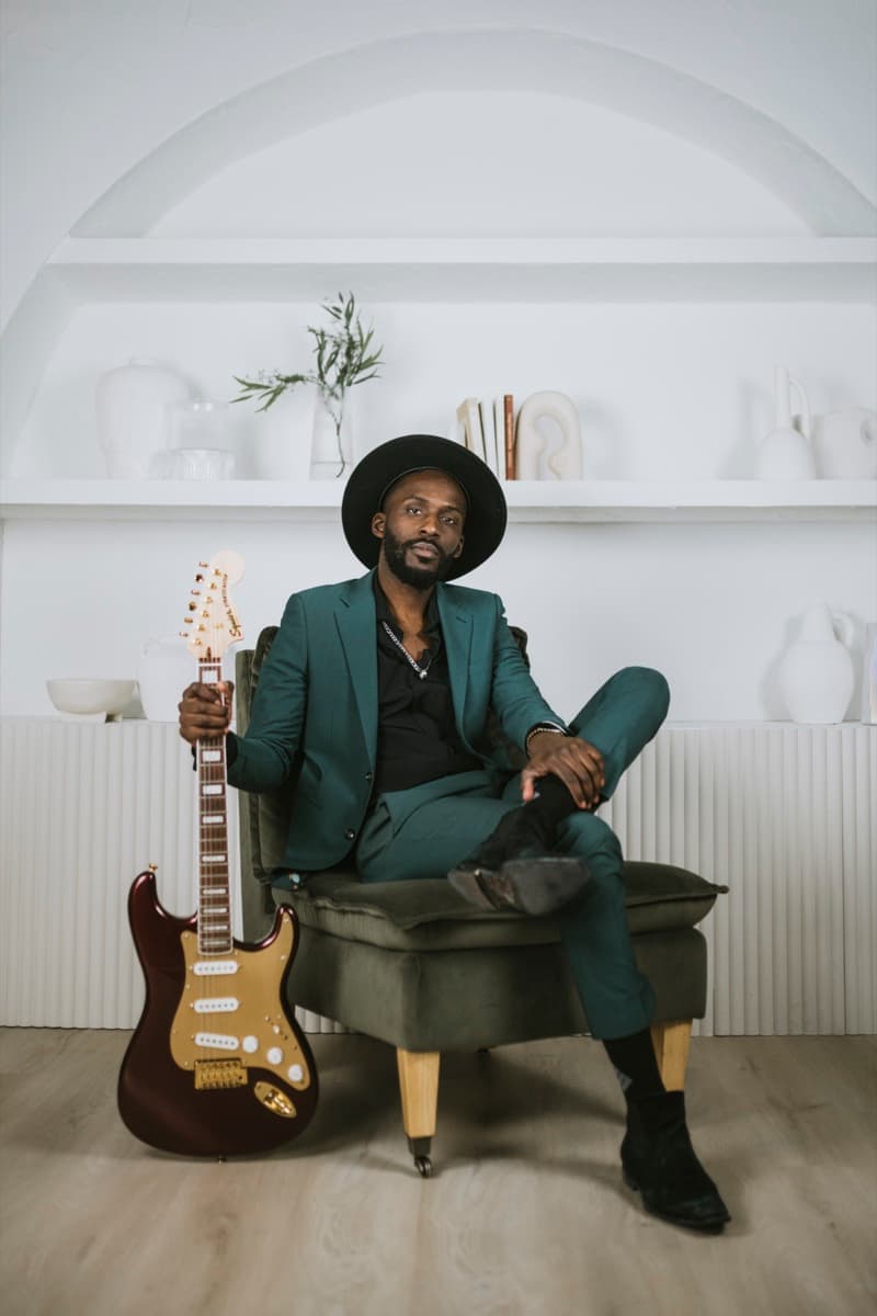 Almyr Jules studio portrait with guitar